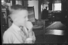 0477_well dressed boy unknown interior, possibly Nebraska