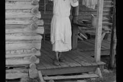 0615_ House wife outside traditional wooden country dwelling