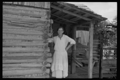 0616_House wife outside traditional wooden country dwelling