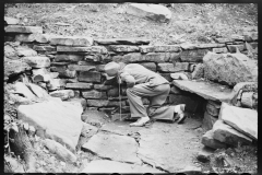 1247_Inspecting a dry stone retaining wall , unknown person and location