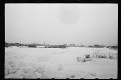 1371_Snowy landscape with distant housing.