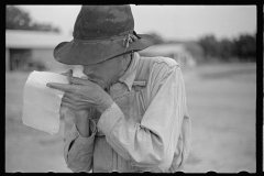 01548_Farmer with poor eyesight reading or making notes