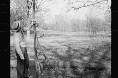 1625_Man examining a large metal bracket possibly for sign ,Tennessee