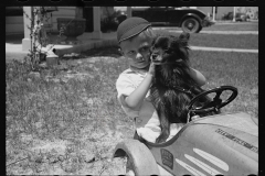 1649_Young boy in his pedal car and dog ,