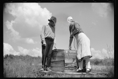 1652_Couple examining  wooden container, Decatur Homesteads , Indiana