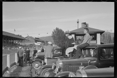 1885_Line of sedans opposite the grandstand at the races, location unknown