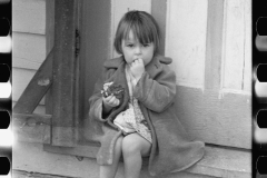 1908_Young girl sitting on unknown doorstep , unknown location