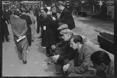 1936_Possibly the unemployed sitting in line , New York City