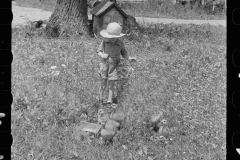 1991_Small child feeding the chickens Scioto farms, Ohio