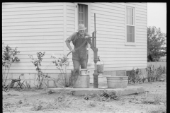 2018_Fetching a bucket of water from pump ( and well ) outside new build house