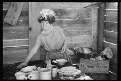 2072_Twelve-year old girl of family of nine, cooking meal in-open lean-to  hut, Tennessee