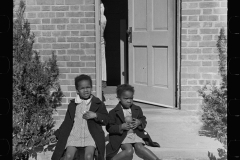 2930_ children sitting on the doorstep of their new home , Newport News Homesteads,