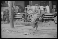 3686_Barefoot boy at front of houses , Charleston, West Virginia