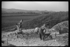 3716_Homesteaders' children playing in pile of sand, Tygart Valley