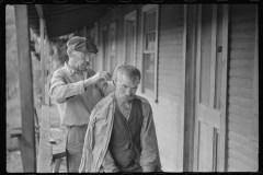 3888_  Haircuts on front porch. Chaplin, West Virginia