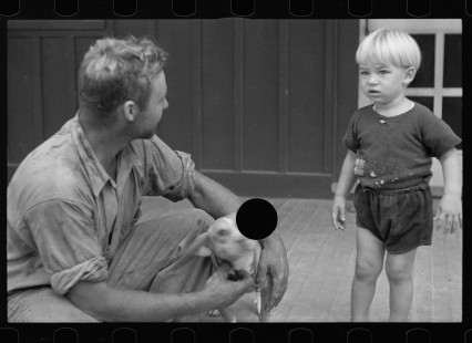 0085_Young resettled farmer with son