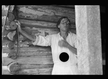 0617_House wife outside wooden country dwelling