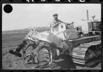 0787_ Powered rear cultivator on tracked vehicle.