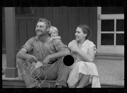 0083_Young resettled farmer, with wife and child